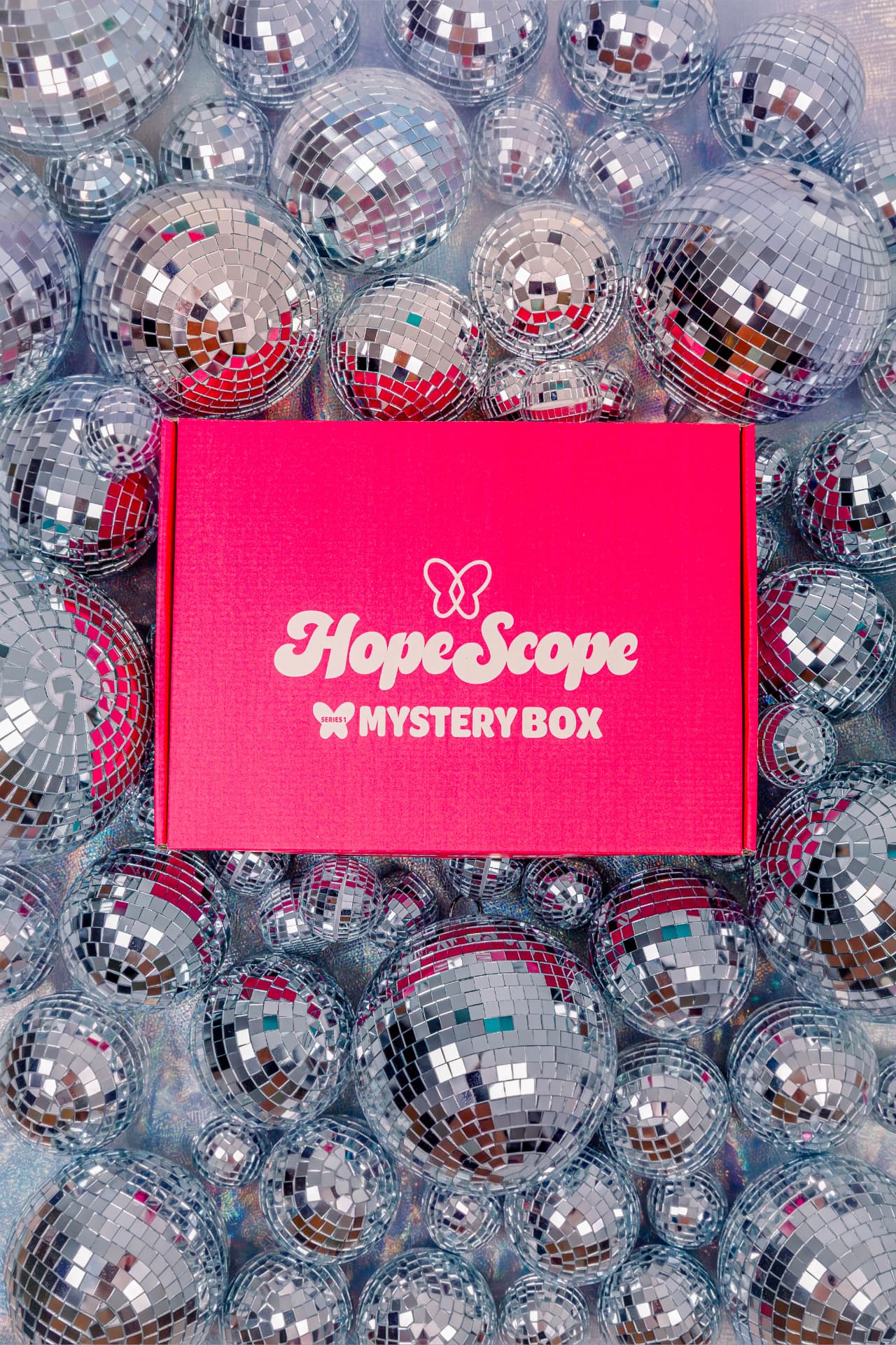 Red HopeScope mystery box on a bed of disco balls